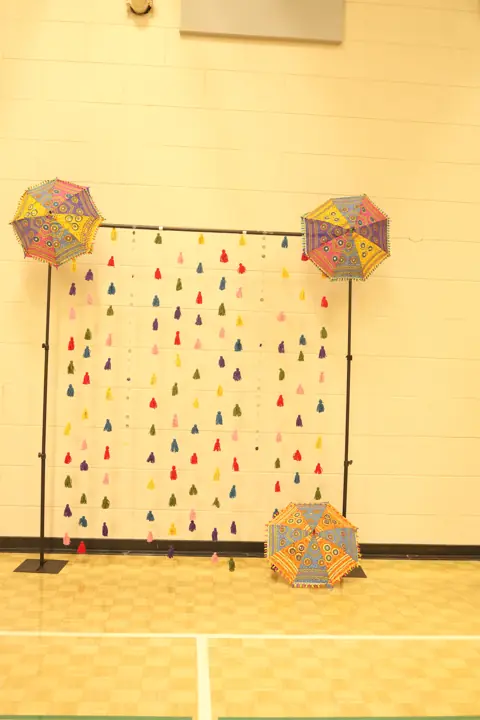 Colourful Navratri photo backdrop with hanging decorations and umbrellas