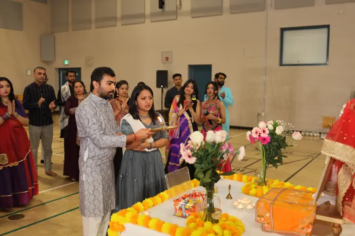 Community members taking part in the Navratri ceremony