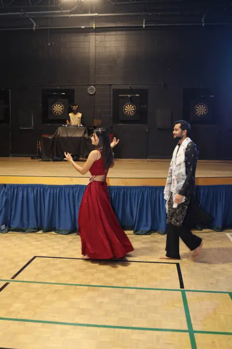 Dancers crossing the hall in front of the stage
