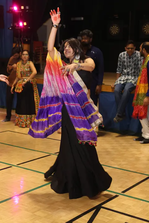 Guest dancing in colourful traditional dress