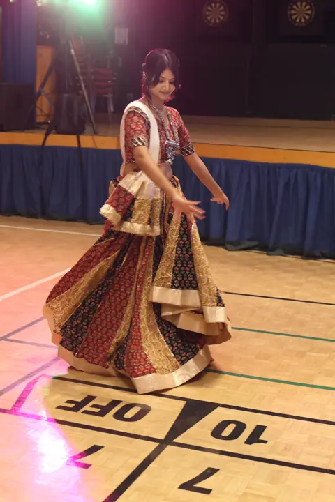 Guest dancing under colourful lights at the celebration
