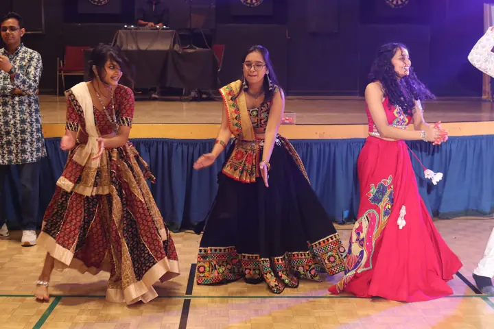 A group of dancers in colourful Navratri outfits