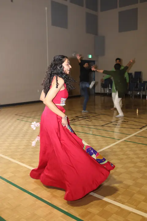 Guest twirling in a red skirt on the dance floor