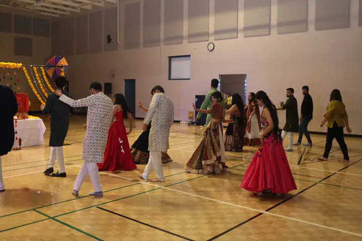 Community Garba dancers celebrating together in the hall